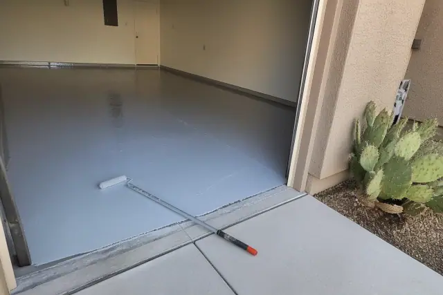 Wet epoxy coating being applied to a residential garage concrete floor in Tucson, AZ.