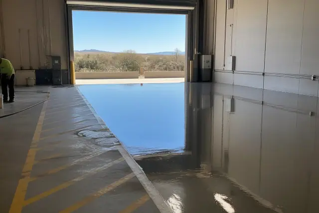 100% solids epoxy coating leveling on an industrial warehouse concrete floor in Tucson, AZ.