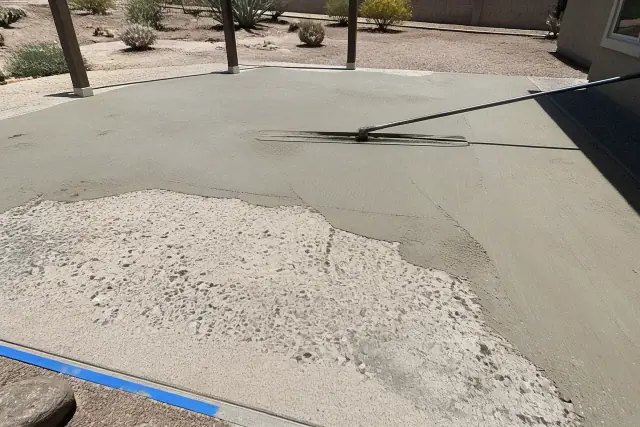 Concrete patio repair with leveling screed marks on an outdoor pad in Tucson, AZ.