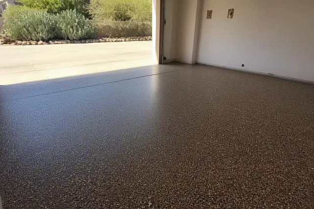 Concrete residential garage floor with Canyon and Coyote flake epoxy finish in Tucson, AZ.
