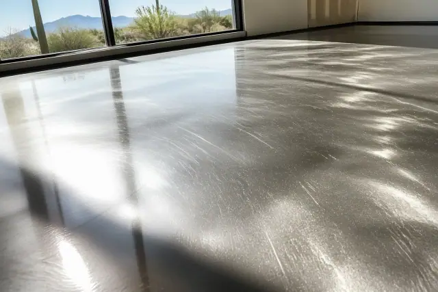 Fine scratches on a clear metallic topcoat on a concrete floor at a Tucson, AZ jobsite.