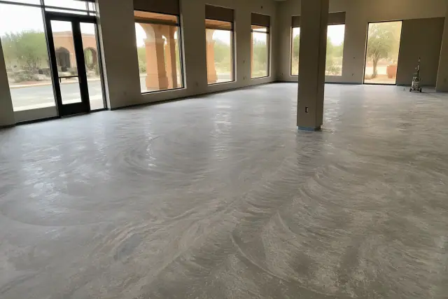 Sanded concrete floor prepared for epoxy installation in a commercial showroom in Sahuarita, AZ.