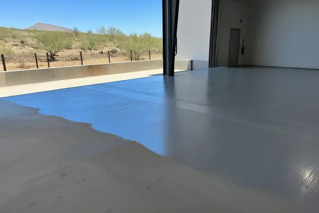 Concrete floor being coated with commercial epoxy at a warehouse loading dock in Drexel Heights, AZ.