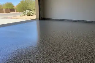 Glossy flake epoxy garage floor in a Tucson, AZ home with prickly pear cacti visible outside.