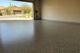 Finished flake epoxy garage floor with a view of saguaro cacti and stucco houses in Tucson, AZ.