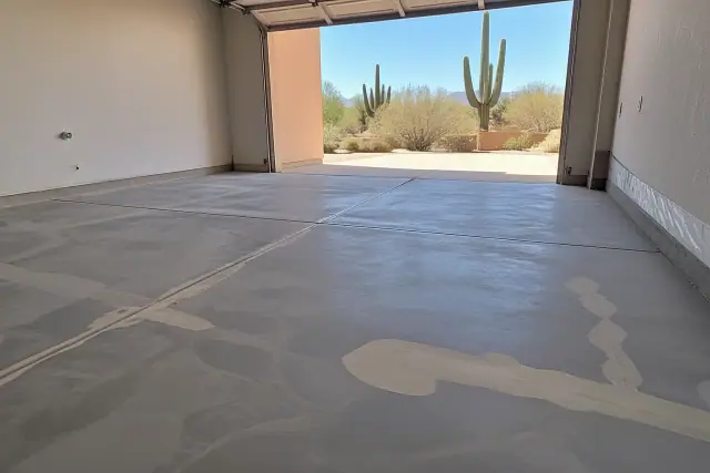 Prepped concrete garage floor with crack filler and grinding marks for a polyaspartic coating project in Tucson, AZ.