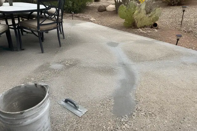 Concrete patio undergoing structural repair and surface leveling in a Tucson, AZ backyard.