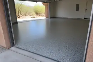 Wide view of a finished flake epoxy garage floor with desert scrub visible in Tucson, AZ.
