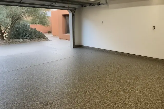 Empty two-car garage with a finished decorative flake epoxy floor in Tucson, AZ.
