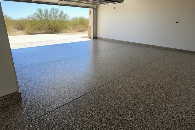 Flake epoxy flooring in an empty two-car residential garage with desert views in Marana, AZ.
