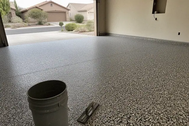Concrete garage floor with freshly broadcasted decorative epoxy flakes in a residential home in Tucson, AZ.