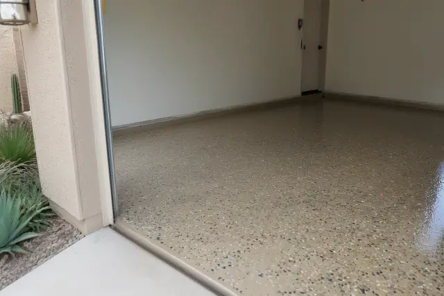 Epoxy flake garage floor with a decorative finish in a residential garage in Casas Adobes, AZ.