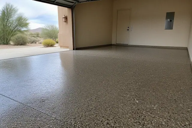 Two-car garage floor in Sahuarita, AZ with a partially applied epoxy flake finish.