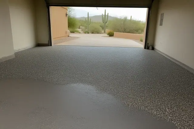 Concrete garage floor with partially applied colored flakes in a home in Catalina Foothills, AZ.