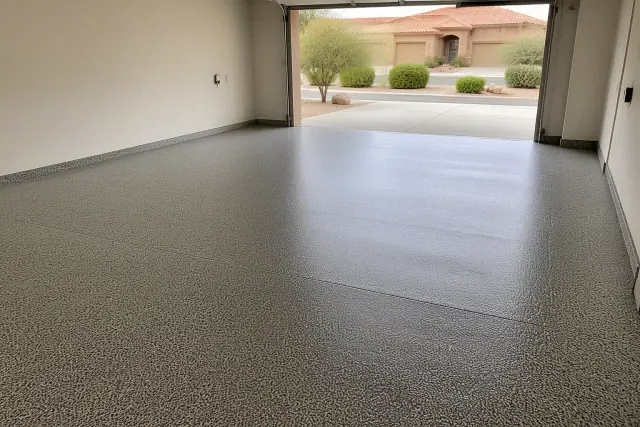 Completed flake epoxy floor in a two-car residential garage with desert landscaping in Green Valley, AZ.