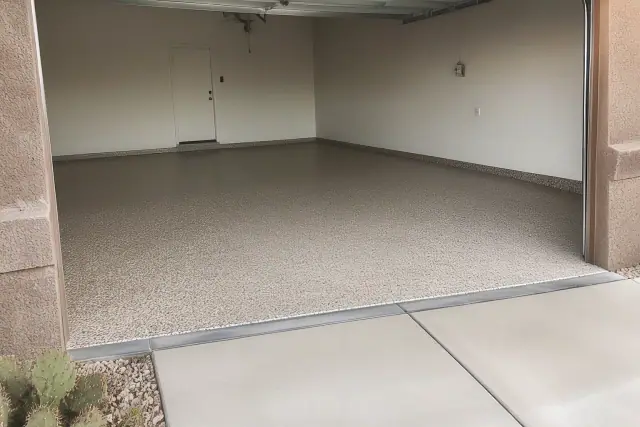 Completed flake epoxy garage floor in a Tucson, AZ home with southwestern architecture and prickly pear cacti.