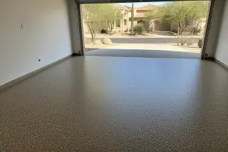 Wide view of a seamless flake epoxy garage floor with Sonoran desert landscaping visible in Tucson, AZ.