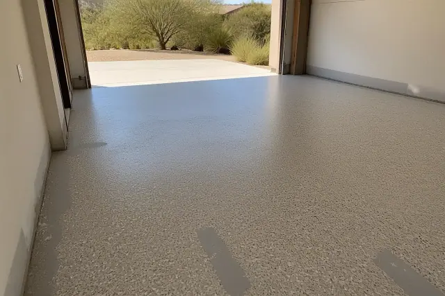 Empty two-car garage with a new epoxy base coat and flake finish in Tanque Verde, AZ.