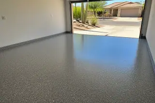Finished flake epoxy garage floor in a residential home in Tucson, AZ with desert landscaping visible outside.