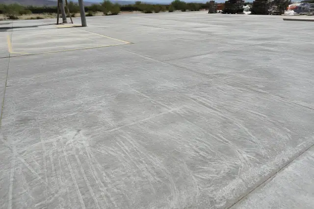 ICRI CSP 3 diamond-ground concrete slab surface under bright sunlight at a worksite in Tucson, AZ.