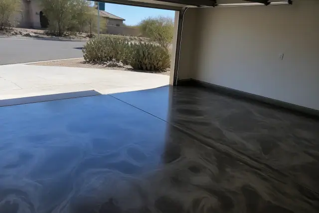 Empty two-car garage with new metallic epoxy flooring in Drexel Heights, AZ.