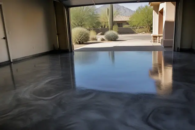 Metallic epoxy garage floor with a glossy finish in an Oro Valley, AZ home, showing desert views through the open door.