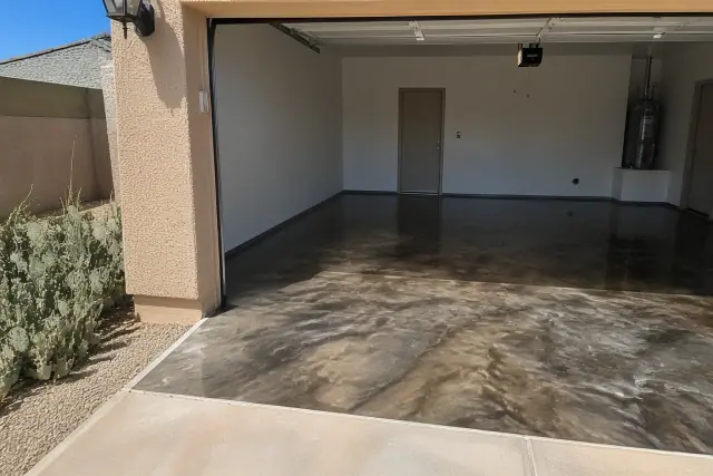 Metallic epoxy flooring in a two-car garage with desert landscaping outside in Tucson, AZ.