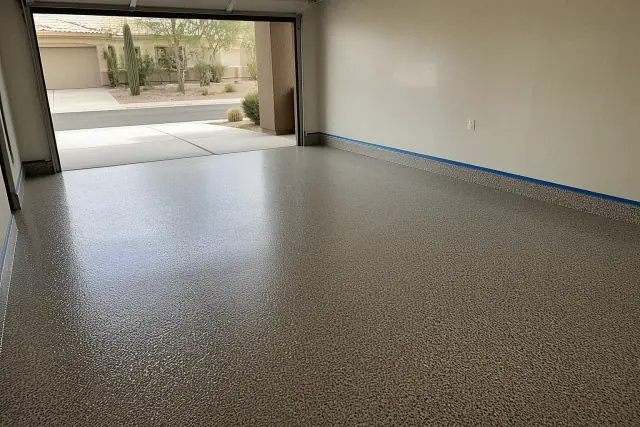 Freshly applied metallic flake epoxy flooring in a residential two-car garage in Tucson, AZ.