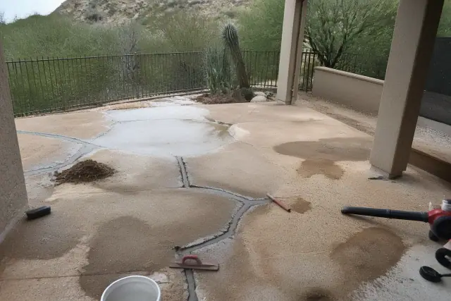 Concrete backyard patio undergoing structural surface leveling and repair in Tanque Verde, AZ.