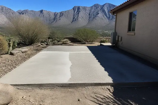 Concrete backyard patio undergoing structural repair and surface leveling in Oro Valley, AZ, with mountain views.