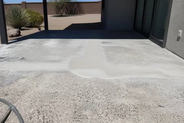 Concrete patio surface being repaired and prepped for epoxy coating in a backyard in Sahuarita, AZ.