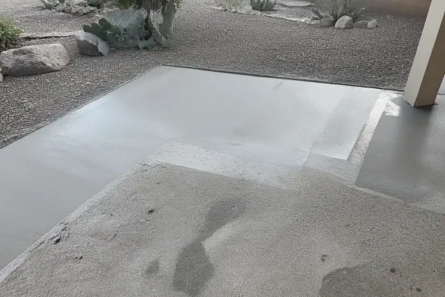 Concrete backyard patio undergoing surface repair and leveling for epoxy coating in Drexel Heights, AZ.