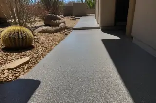 Textured anti-slip polyaspartic coating on an outdoor walkway in Tucson, AZ with Sonoran desert cacti.