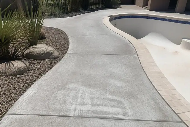 Drained swimming pool and concrete walkway prepared for resurfacing in Tucson, AZ.