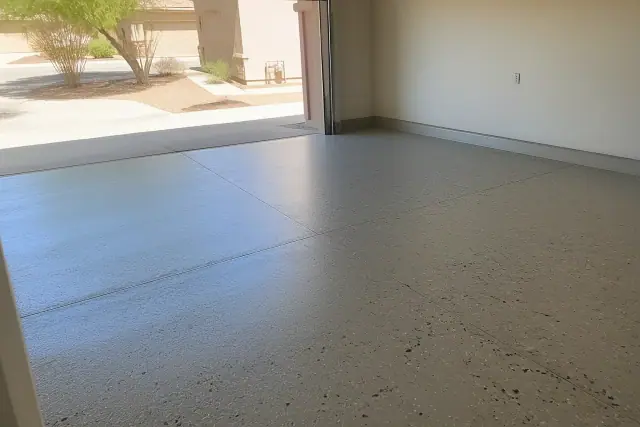 Polyaspartic flake floor coating in an empty residential two-car garage in Marana, AZ.