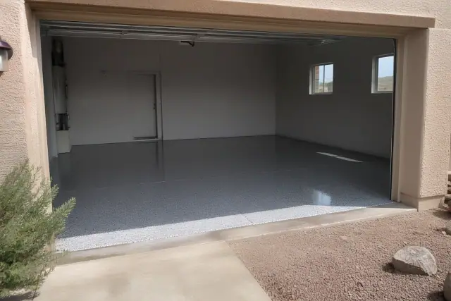 Concrete garage floor with decorative flakes and preparation dust in South Tucson, AZ.
