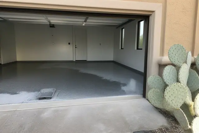 Polyaspartic topcoat being applied to an empty residential garage floor in Tucson, AZ.