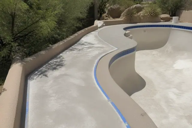 Concrete pool deck surface preparation with blue painter's tape at a residential project in Oro Valley, AZ.