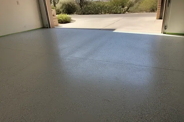 Concrete garage floor with base coat and flakes in a residential home in Tucson, AZ.