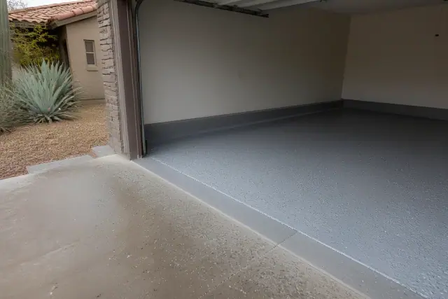 Residential garage floor with partially applied flake epoxy finish in Tucson, AZ.