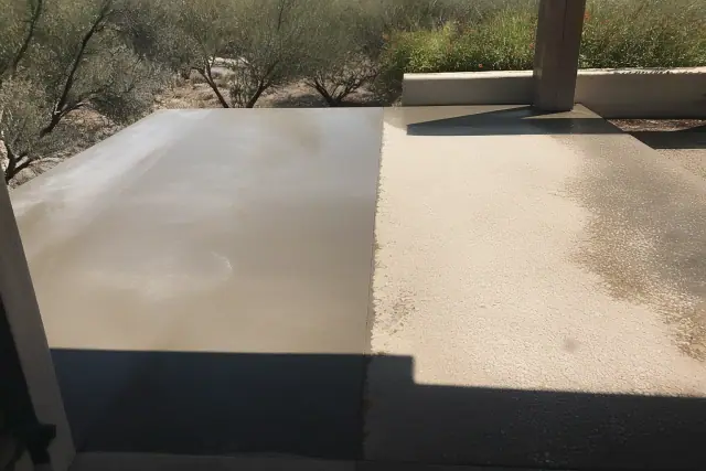 Concrete patio repair with aggregate surface preparation in a Tucson, AZ backyard with desert landscaping.