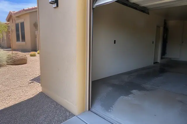 Empty residential garage with concrete floors prepared for a flake finish at a home in Tucson, AZ.