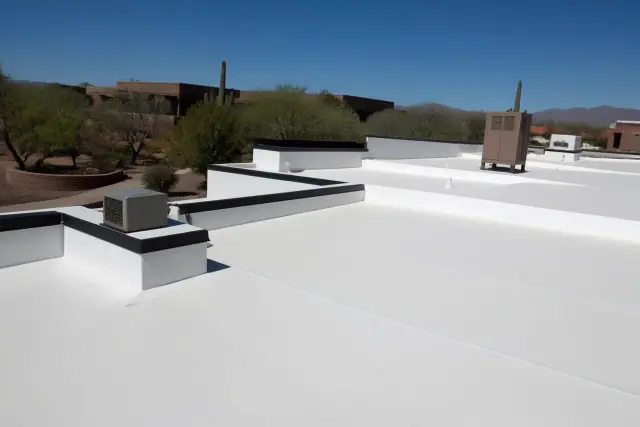 Professional applying heat-welded seams to a commercial roof in Tucson, AZ with desert landscaping in the background.