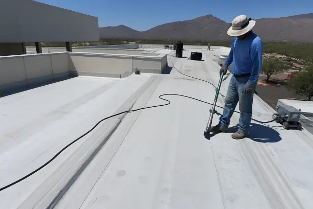 Professional applying heat-welded seams to a commercial membrane roof in Tucson, AZ.