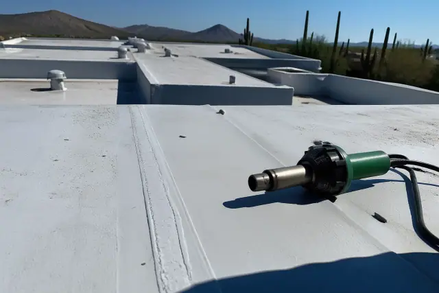 Heat-welded seams on a commercial flat roof in Tanque Verde, AZ with saguaro cacti in the background.