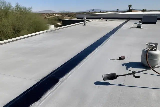A fresh heat-welded seam patch on a commercial flat roof during repairs in Flowing Wells, AZ.