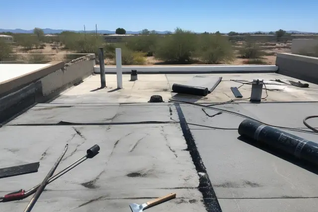 Flat roof repair with heat-welded seams on a commercial building rooftop in Drexel Heights, AZ.