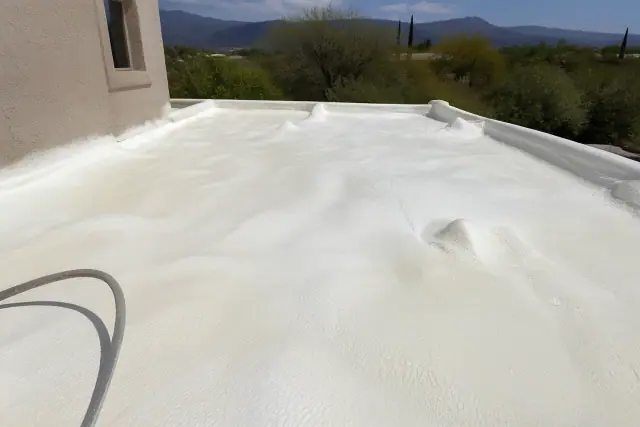 Polyurethane foam roofing being applied to a residential roof in Casas Adobes, AZ.