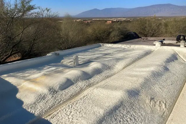 Contractor applying polyurethane foam insulation to a roof in Marana, AZ.