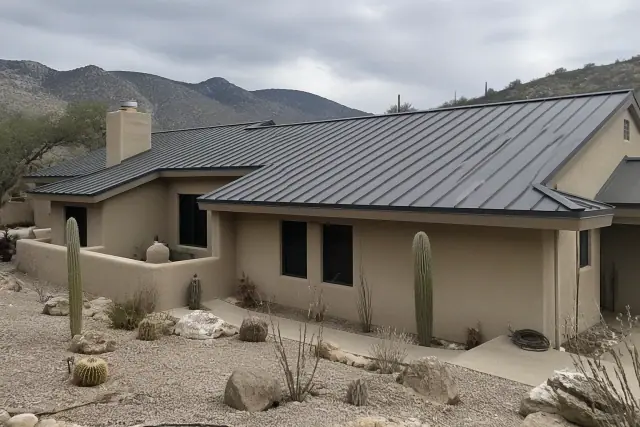 Standing seam metal roof on a stucco home with Catalina Mountain foothills in the background in Oro Valley, AZ.